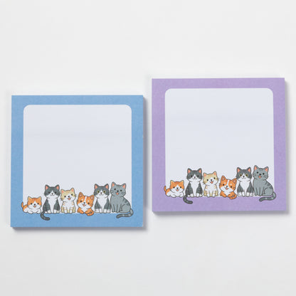 Two square sticky note pads with rounded corners are shown on a light gray background. The left pad has a light blue border and the right pad has a lavender purple border.