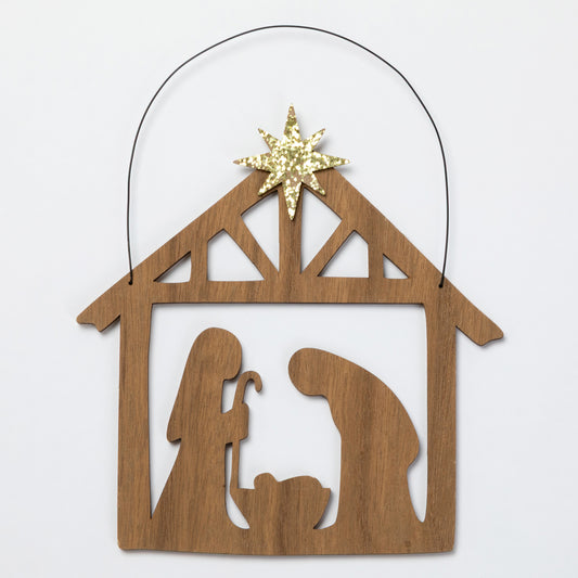 A wooden Nativity scene ornament with a star on top, shown on a plain light background.