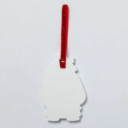 The plain white back of a Christmas ornament with a red glittery hanging ribbon, shown against a plain light gray background.