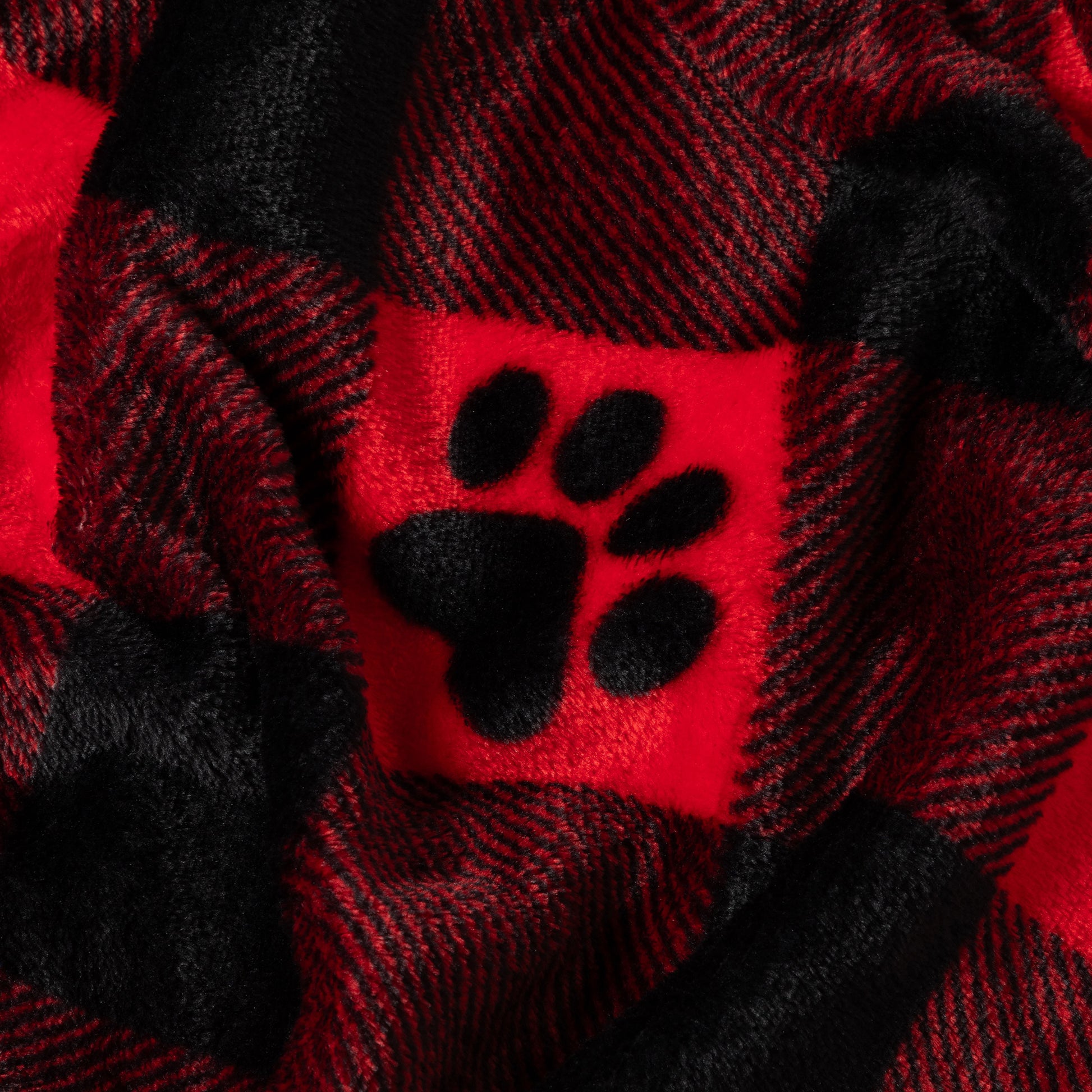 Red and black plaid fabric with a paw print design