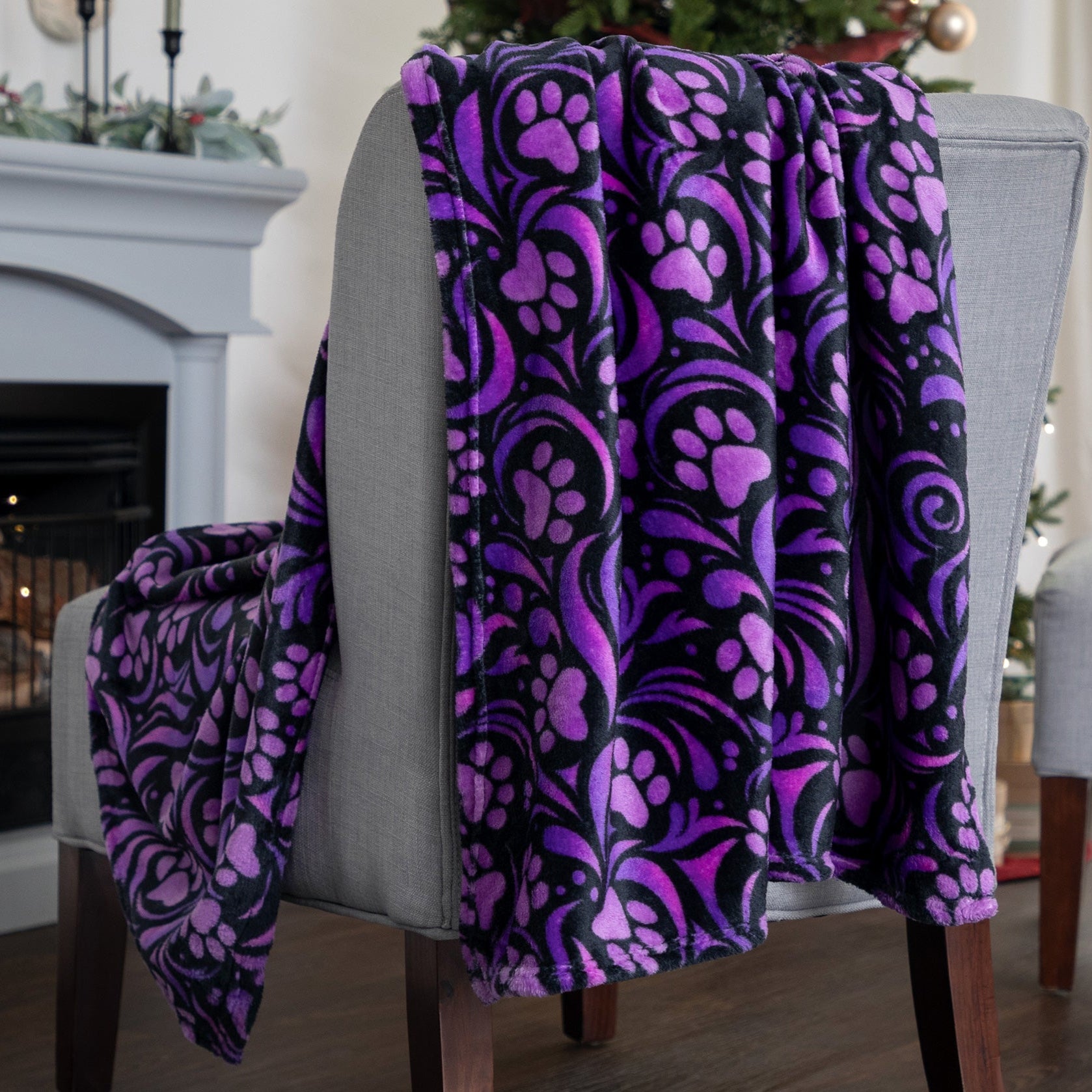 Purple and black patterned blanket draped over a chair in a living room setting.