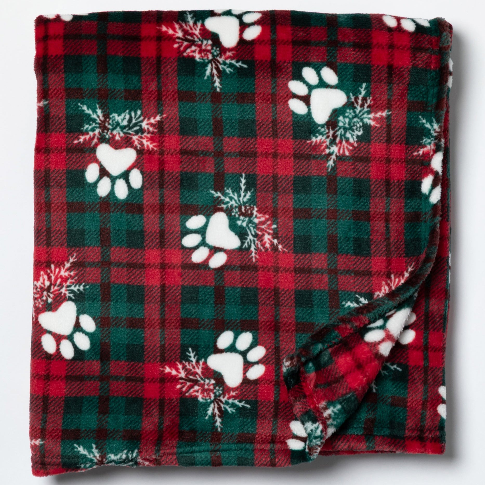 Red and green plaid blanket with white paw prints and snowflakes on a white background