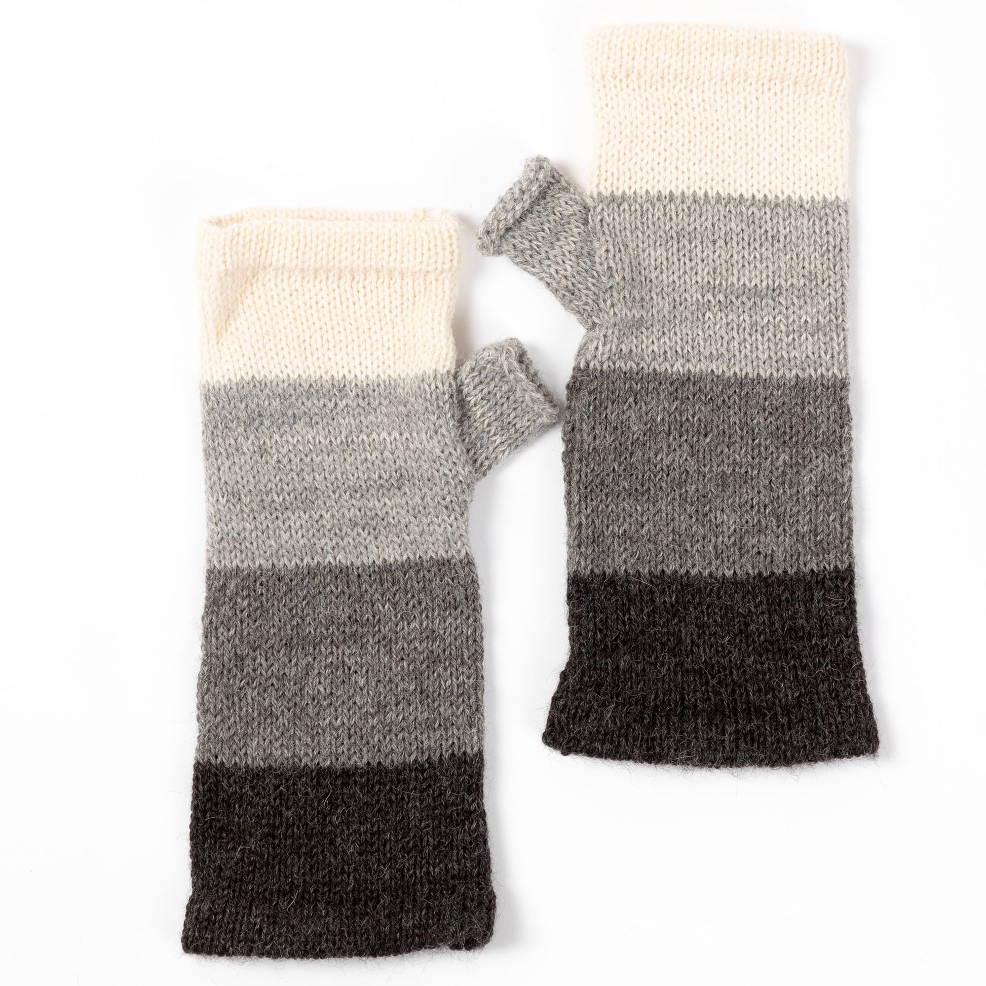 a pair of alpaca fingerless mittens in shades of gray made from alpaca wool on a white background