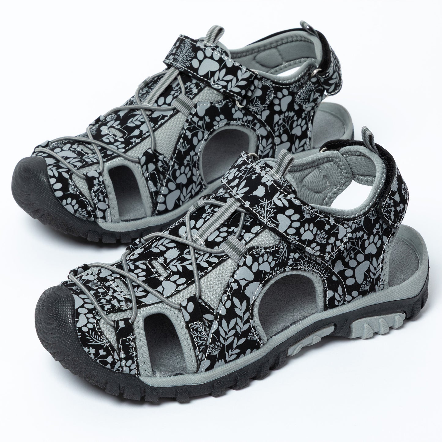Pair of black and gray patterned sandals on a white background