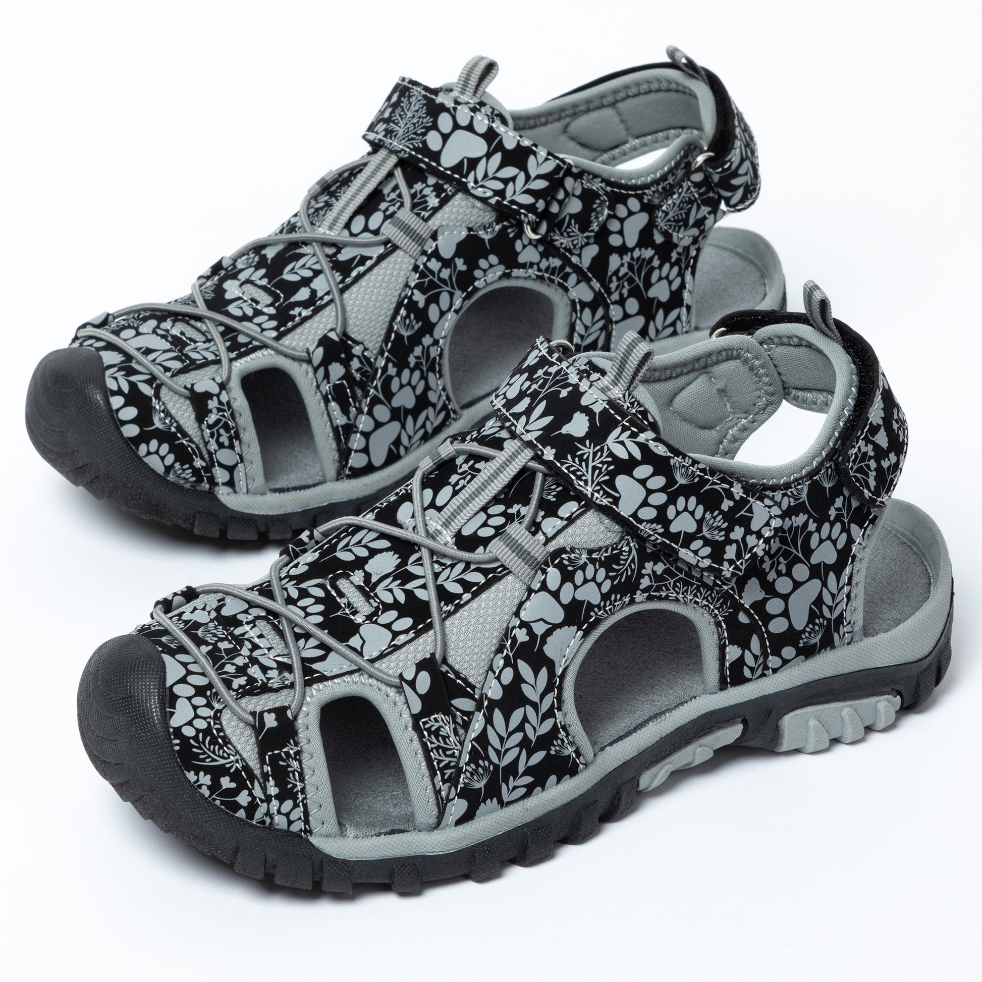 Pair of black and gray patterned sandals on a white background