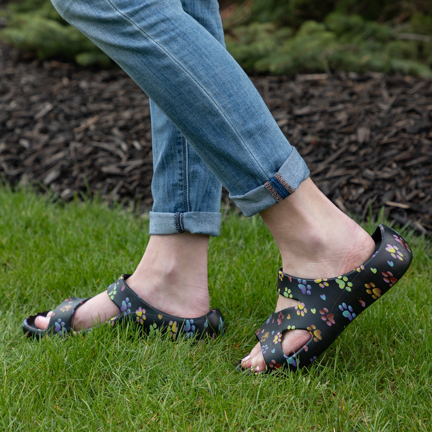model wearing, ombre paws with hearts black slide sandals on grass