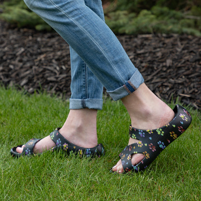 model wearing, ombre paws with hearts black slide sandals on grass