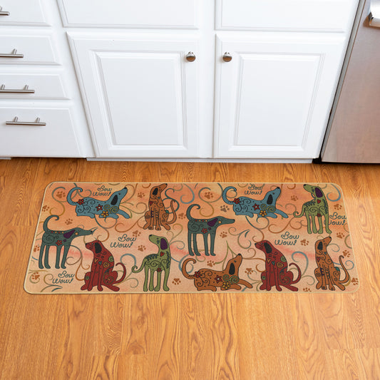 A rectangular, cushioned floor runner with a colorful pattern featuring stylized dogs and paw prints, placed on a wooden floor with part of a wooden cabinet visible in the background.