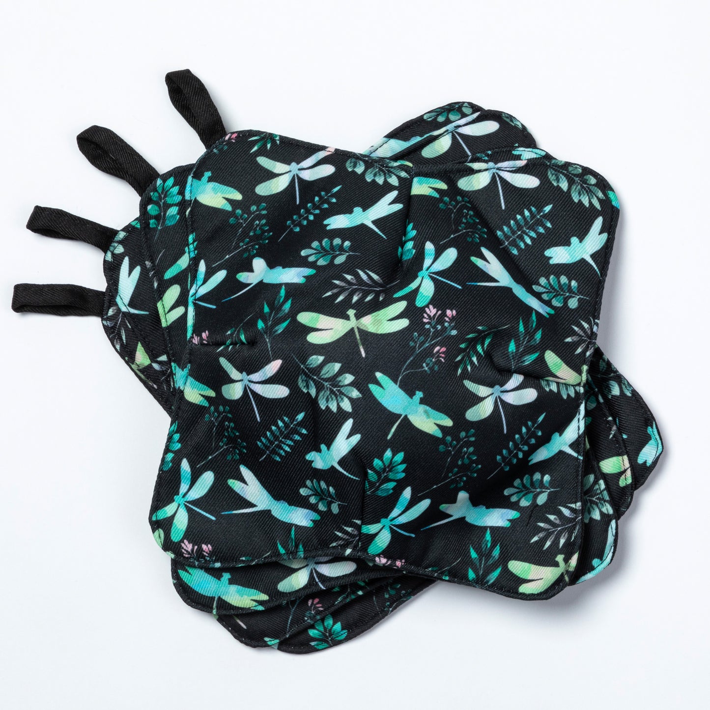 A set of four bowl cozies with various patterns, including a dragonfly design, Dragonfly Garden