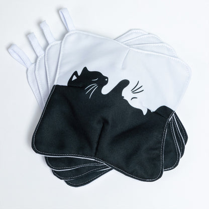 A set of four bowl cozies with various patterns, including a cat print design, snuggle cats