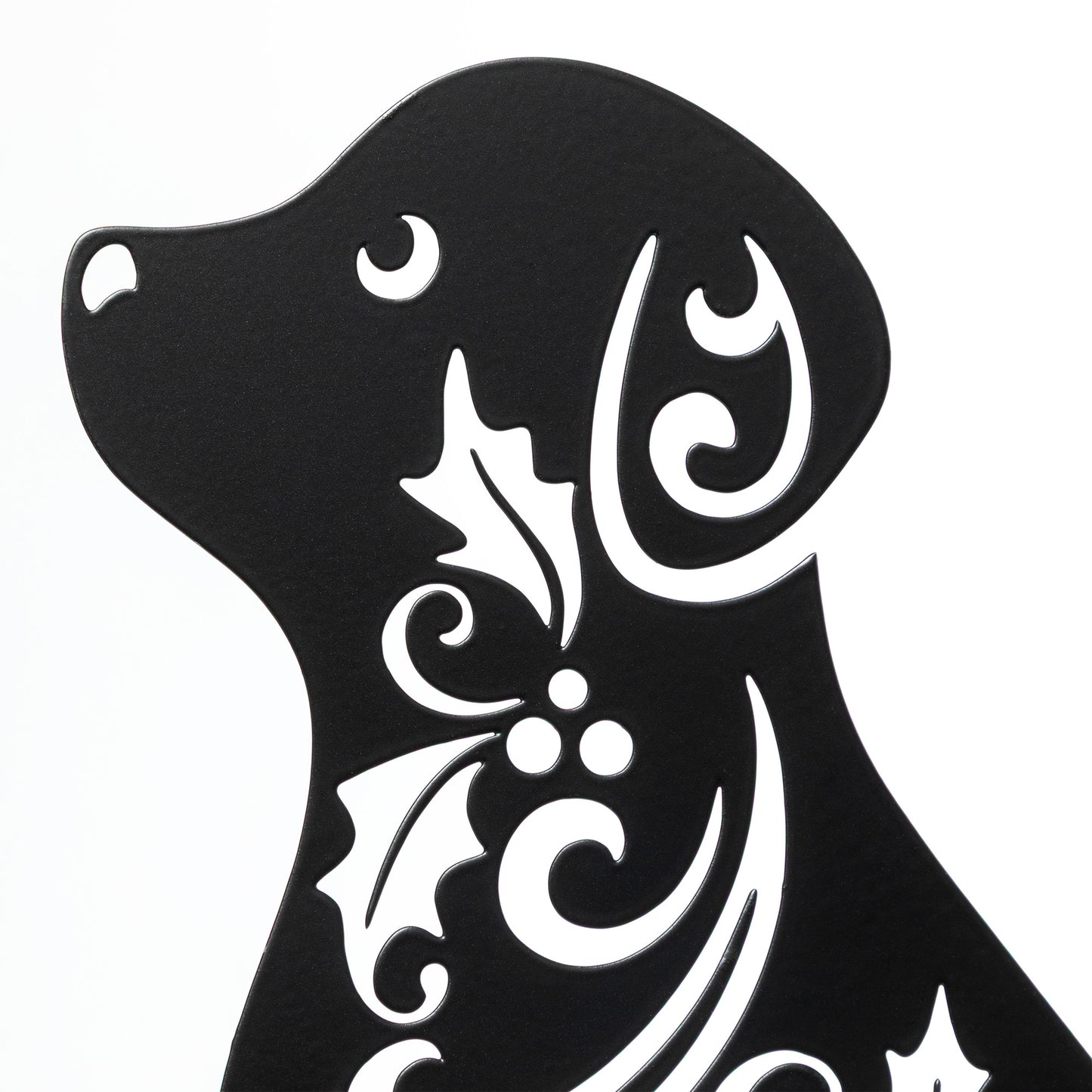 Black silhouette of a dog with white decorative patterns on a white background