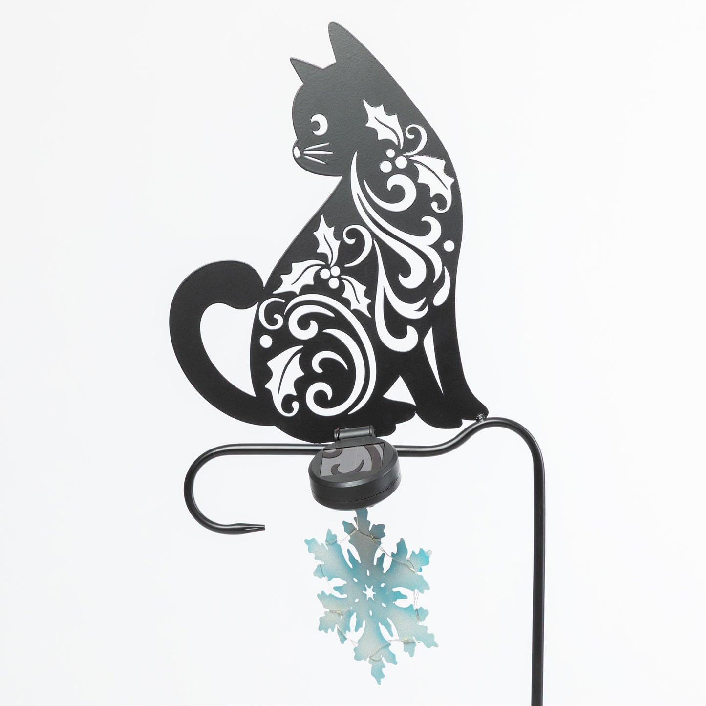Decorative metal cat with snowflake design on a white background