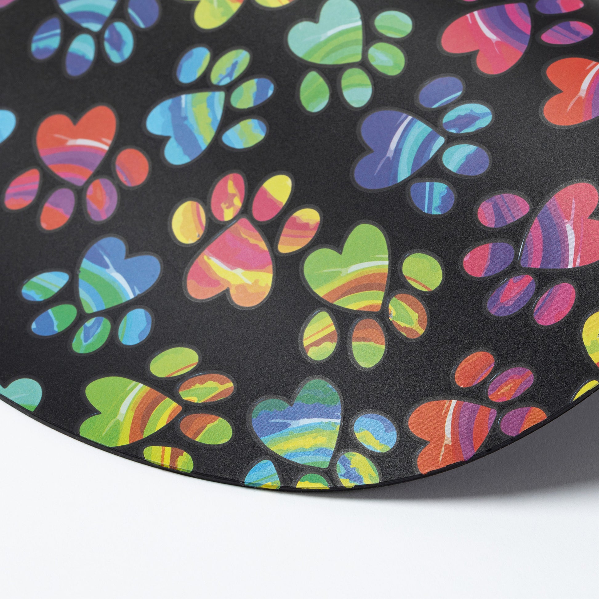 Silicone non-slip jar opener with colorful paw prints on a black background