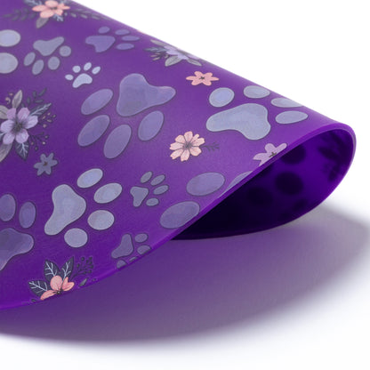 Silicone non-slip jar opener with purple paw prints and flowers.