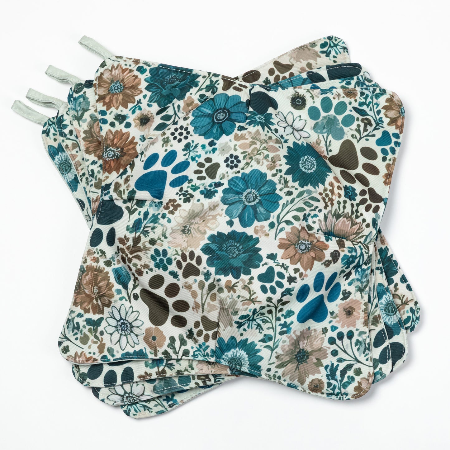 A stack of paw print and floral plate cozies on a white background.