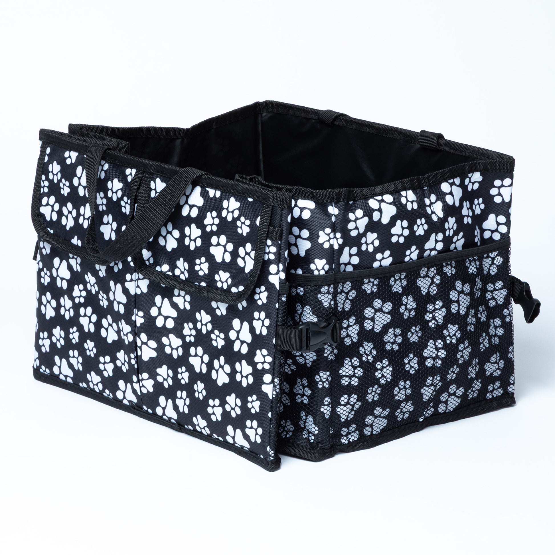 White paw print patterned car trunk organizer with pockets on the front, and a mesh pocket on the side.