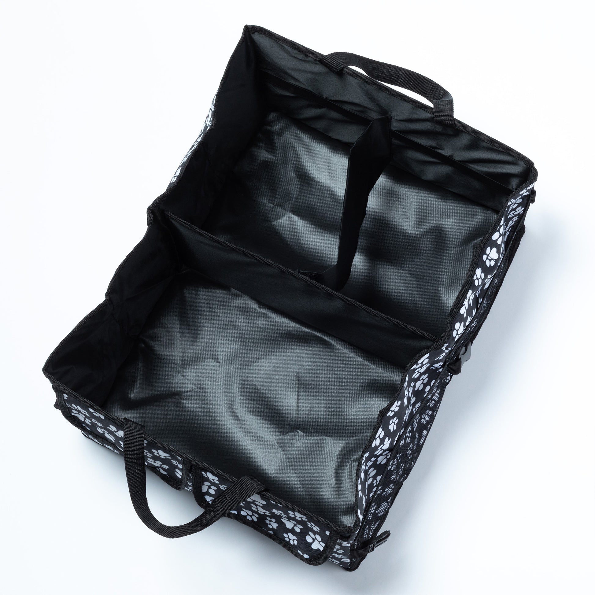 View from above a car trunk organizer, with 3 large compartments, and handles.