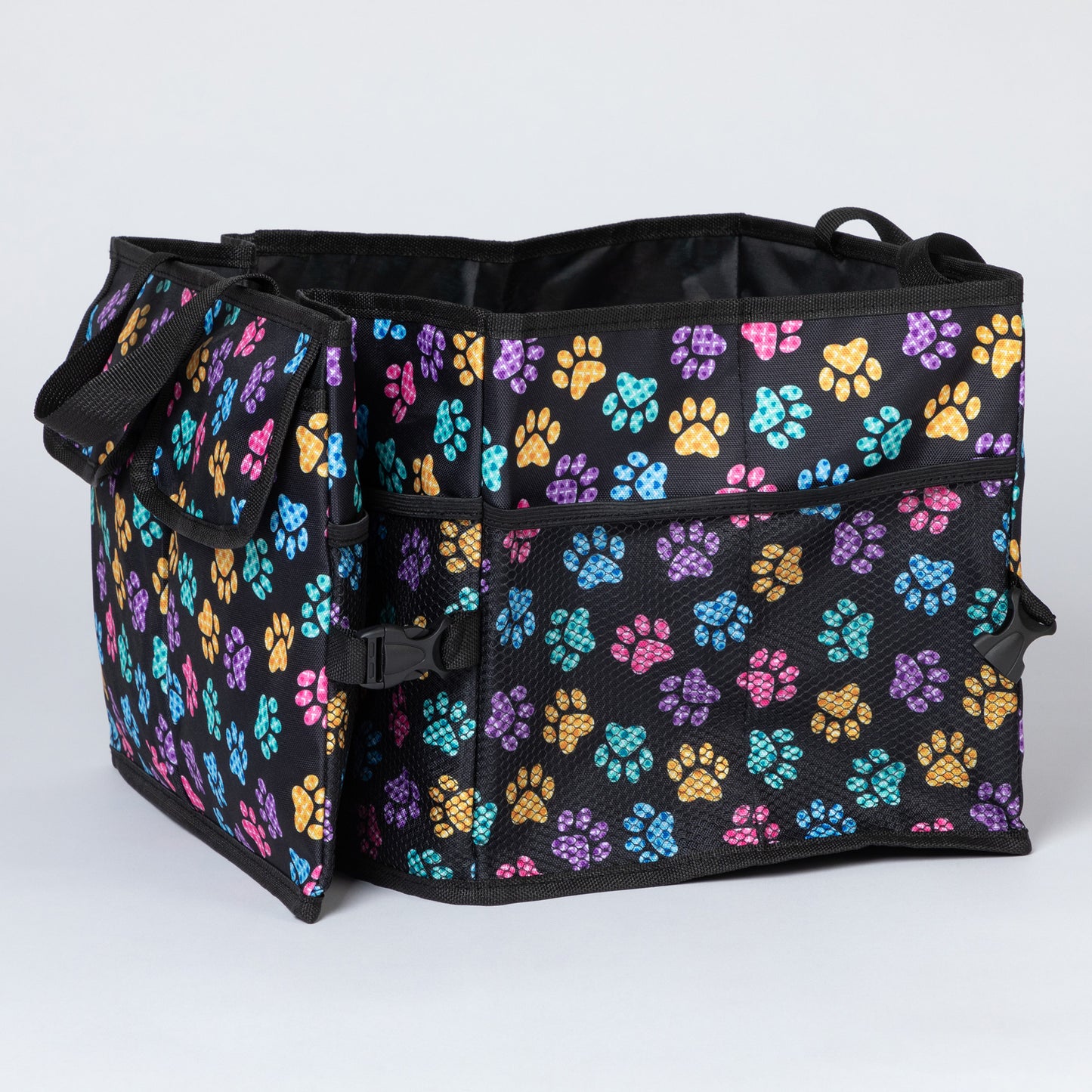 Side view of a colorful paw print patterned  car trunk organizer, with a collapsible side with a buckle, and a side mesh pocket.