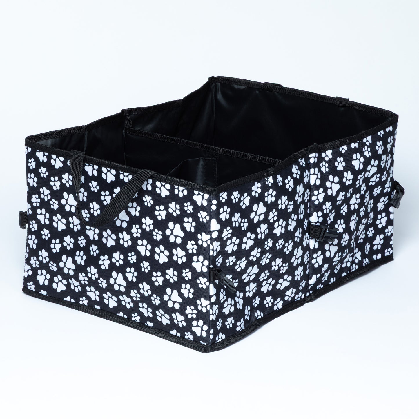 White paw print patterned car trunk organizer with buckles/clips on the side for adjustable size and collapsibility/storage, on a white background.