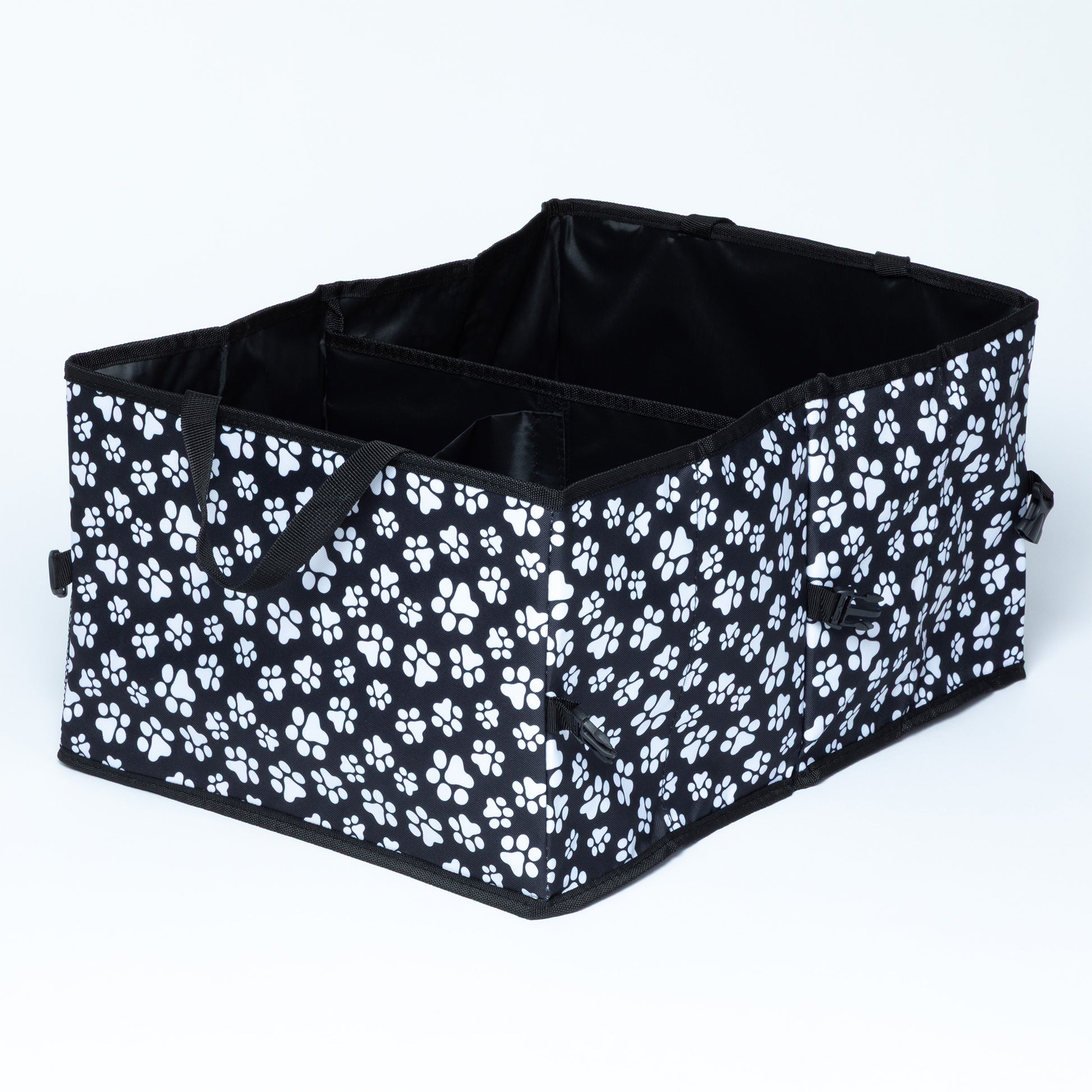White paw print patterned car trunk organizer with buckles/clips on the side for adjustable size and collapsibility/storage, on a white background.