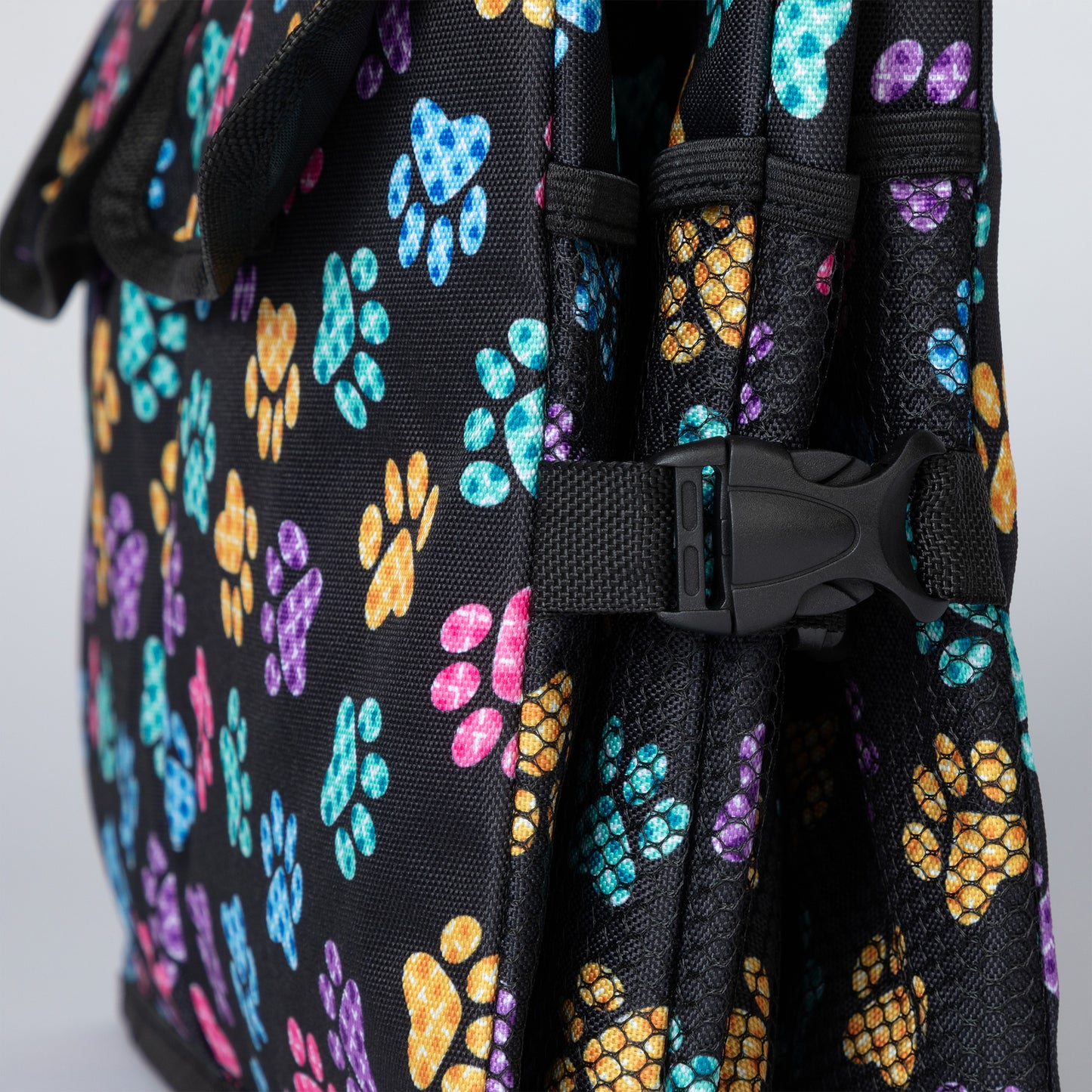 Close up of a buckle on the side of a collapsible trunk organizer, folded flat.