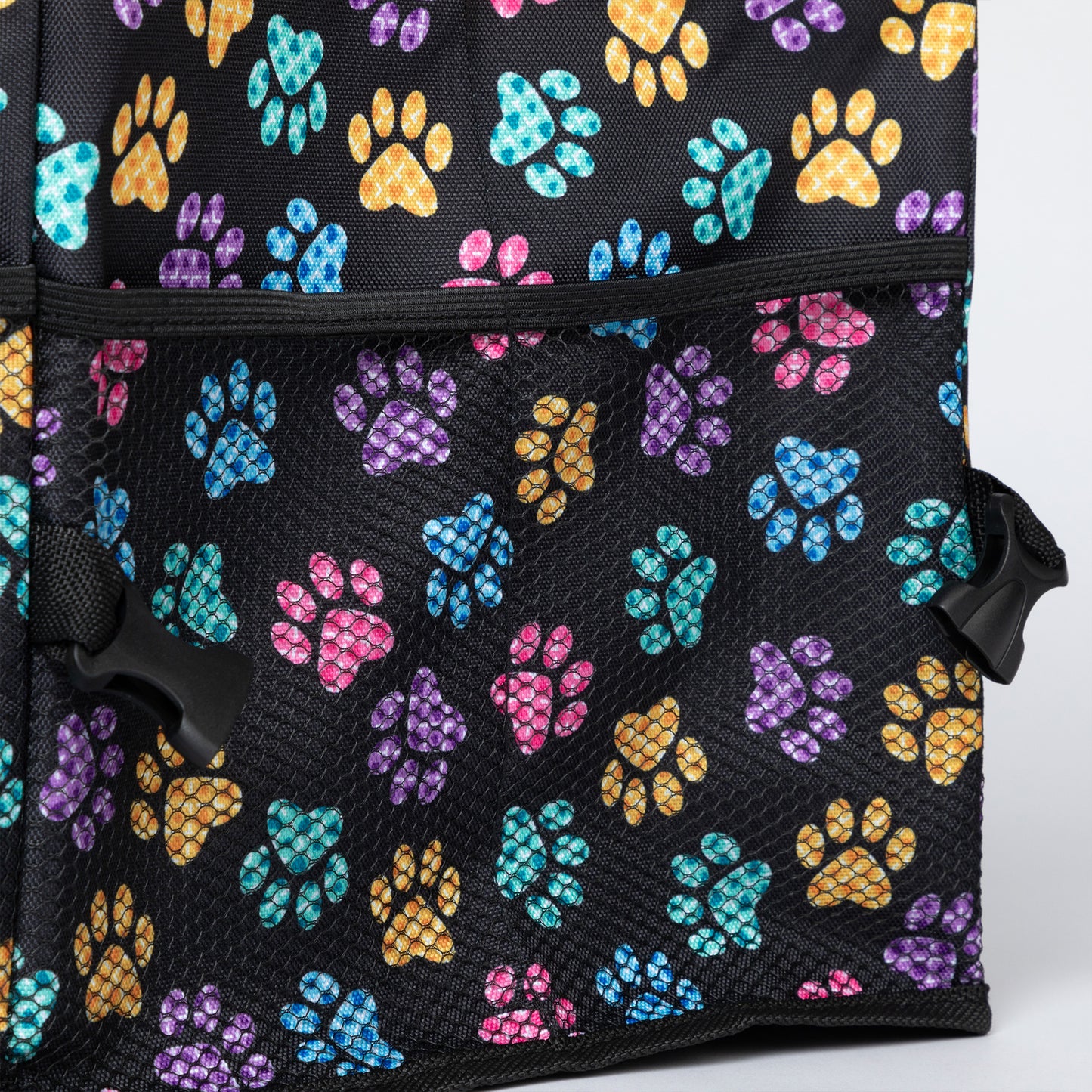 Mesh pocket on the side of a collapsible car trunk organizer, patterned in colorful paw prints.