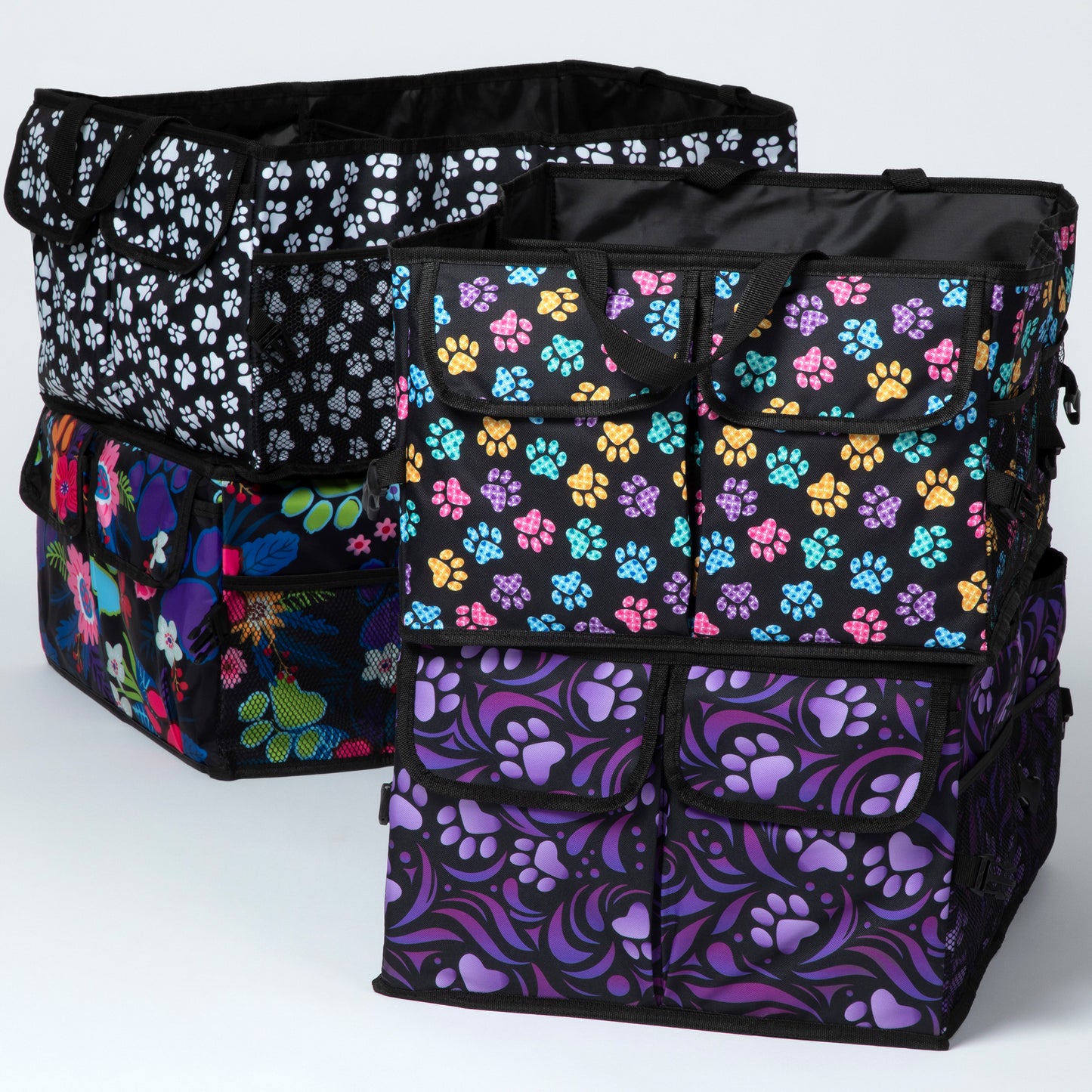 A collection of collapsible car trunk organizers with paw print designs in various colors.
