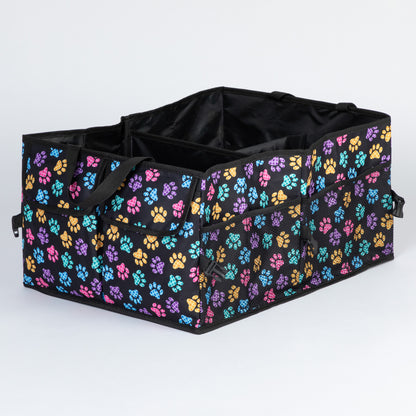 A paw print patterned car trunk organizer with pockets on the front, and a mesh pocket on the side, on a white background.
