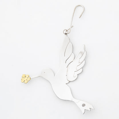 Decorative silver tone dove ornament with gold accents on a white background