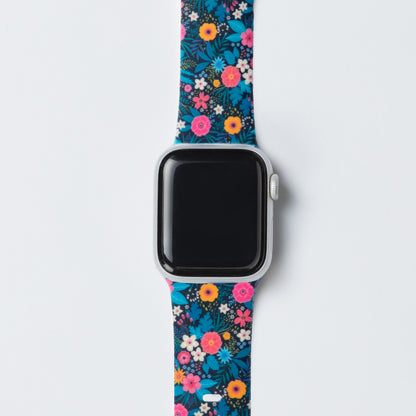 Smartwatch with a colorful floral patterned band on a light gray background