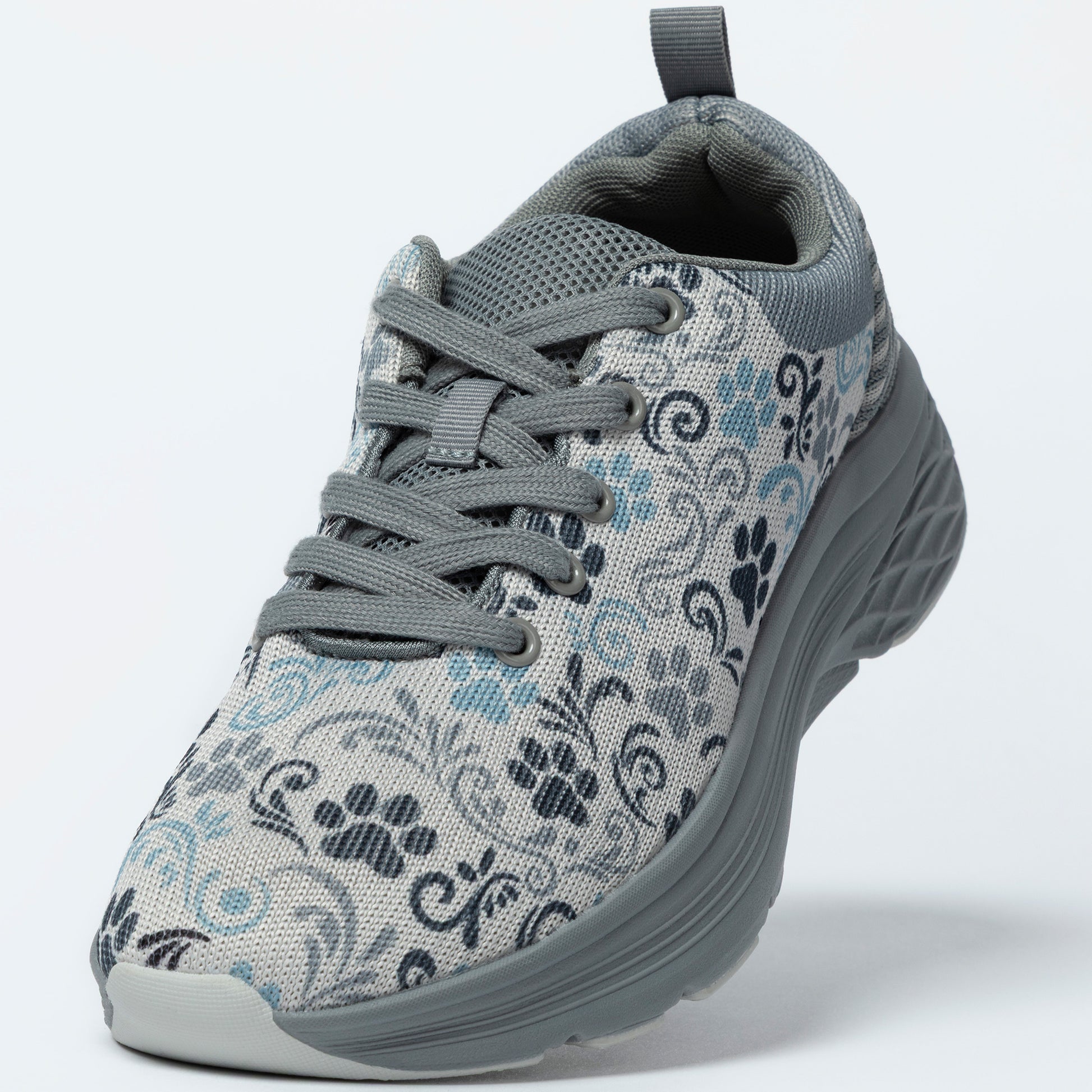 Gray sneaker with floral and paw print pattern on a white background