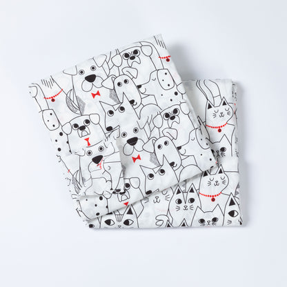 A folded white set of sheets featuring a playful black line-art pattern of various dogs and cats with small red bow ties and collar accents, set against a clean white background.