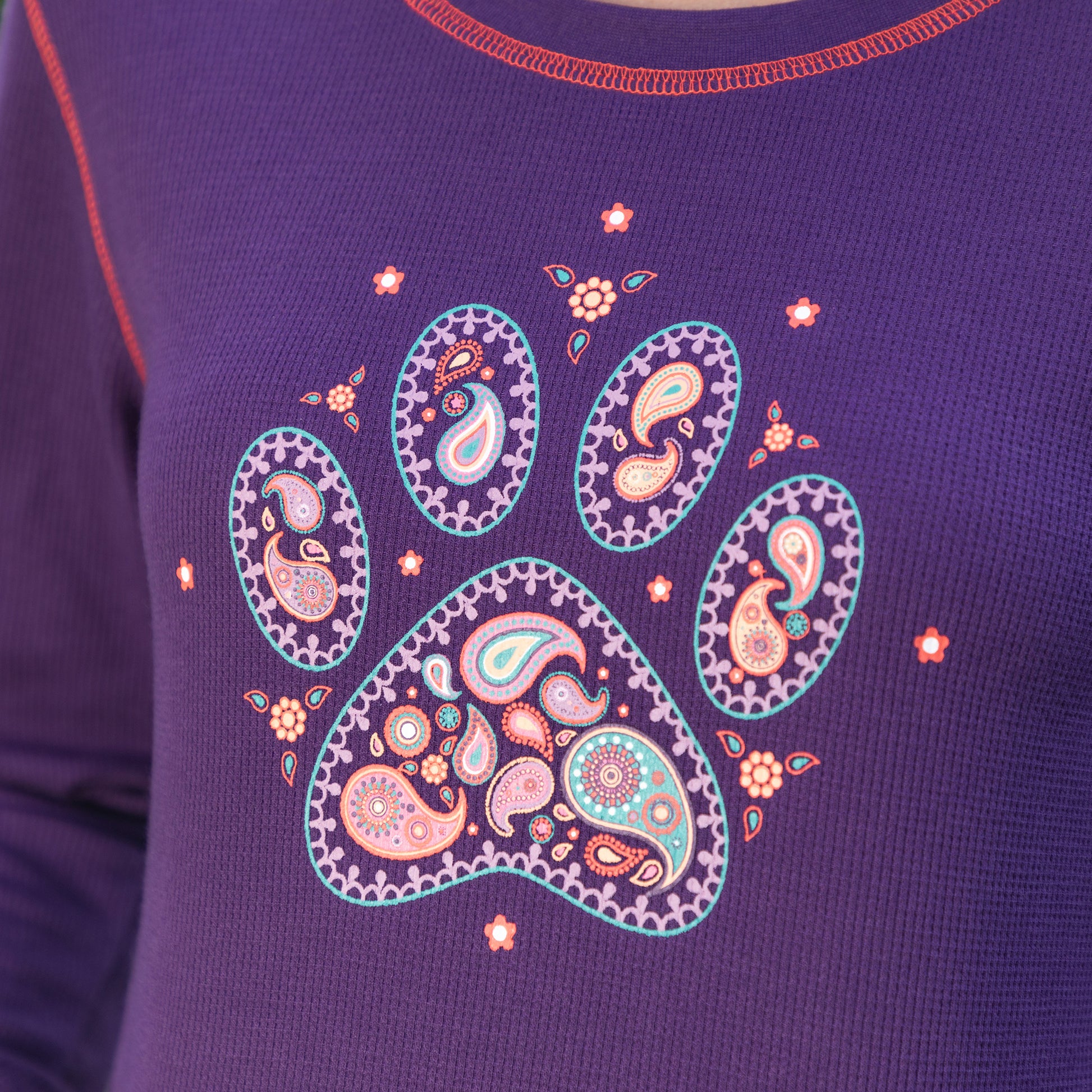 Purple paisley paw print design on the front of a purple thermal crew neck long sleeve tee.