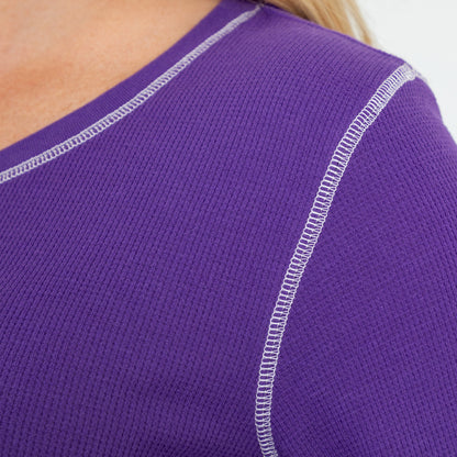 Close up of purple thermal long sleeve tee with white contrast stitching on the neck and shoulder.
