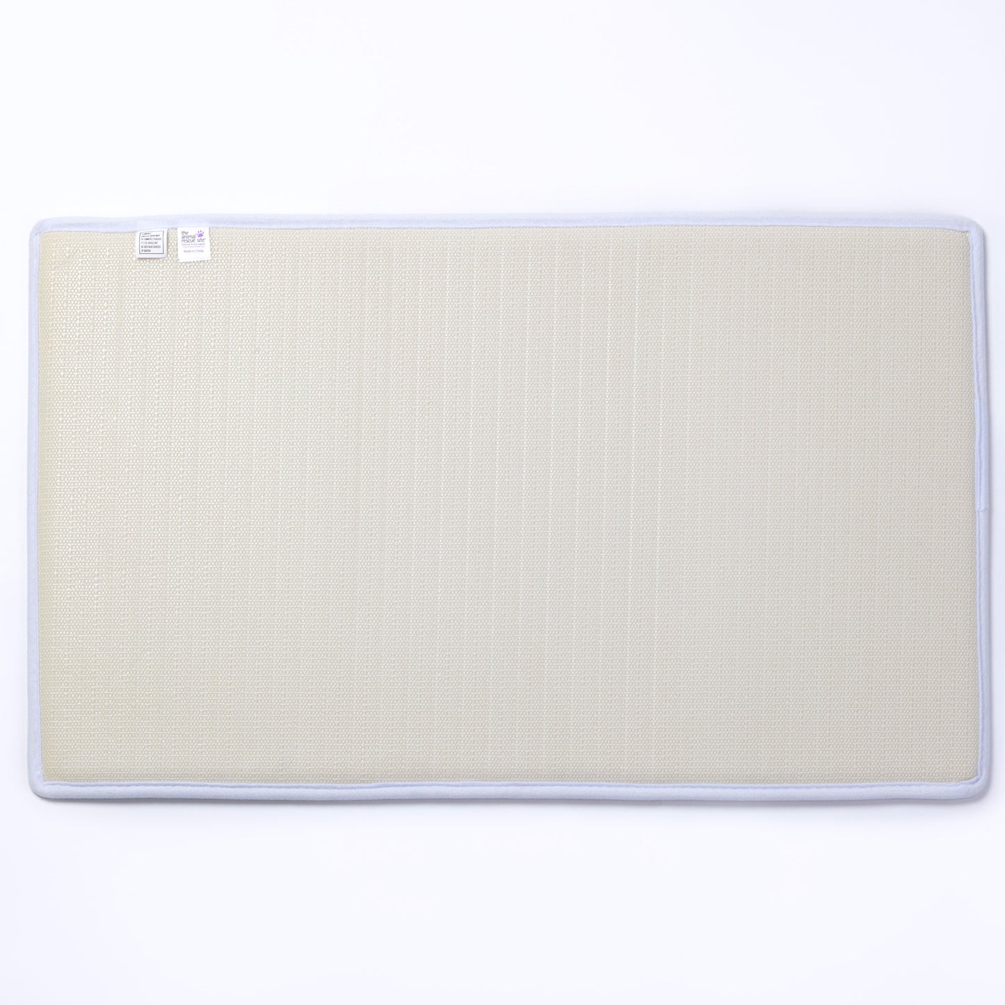 The backing of a beige mat with a white border on a white background