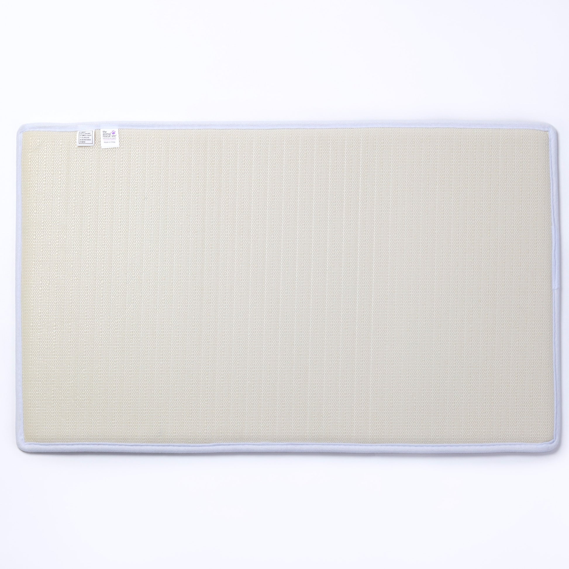The backing of a beige mat with a white border on a white background