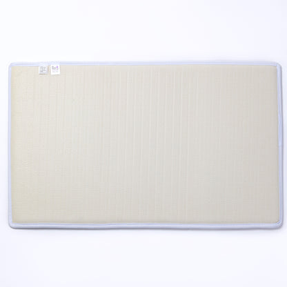 The backing of a beige mat with a white border on a white background