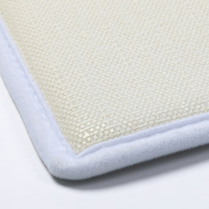 Close-up of non-slip backing textured mat with a white border on a light gray background