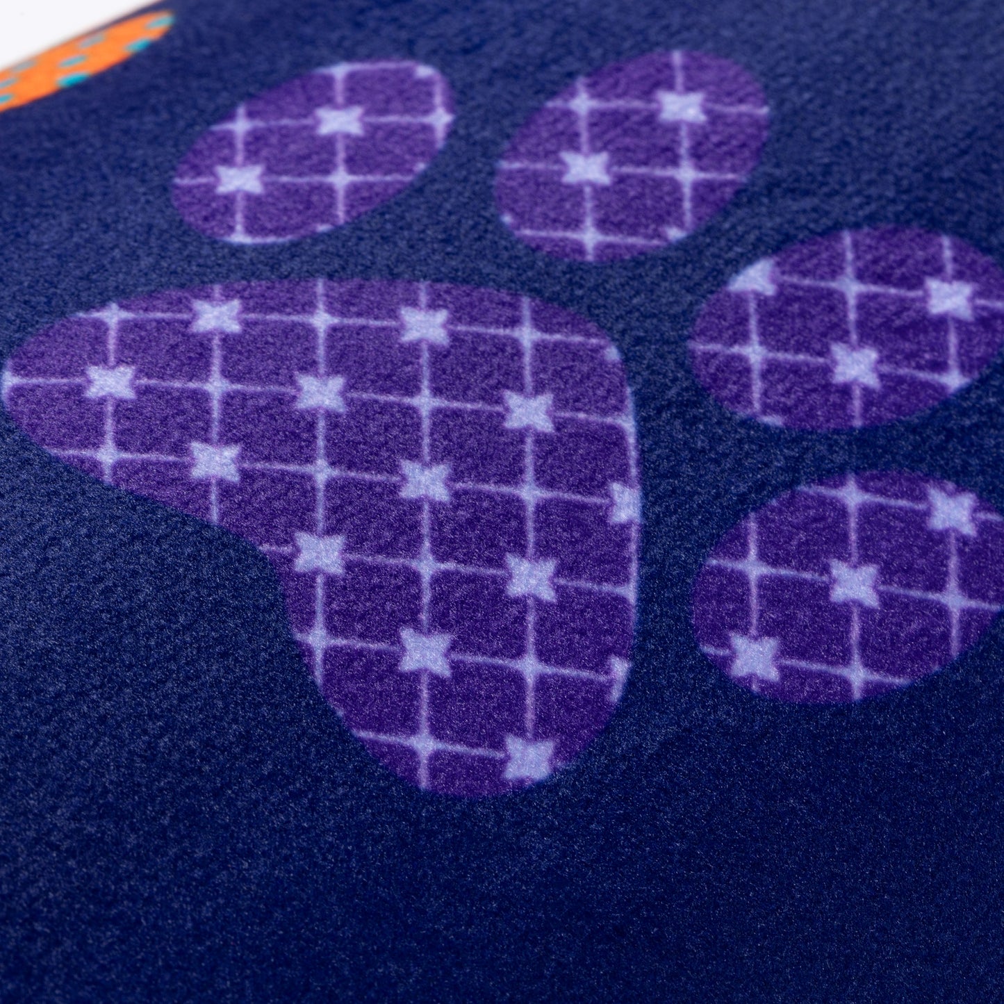 Close-up of a blue memory foam floor mat with a paw printed design.