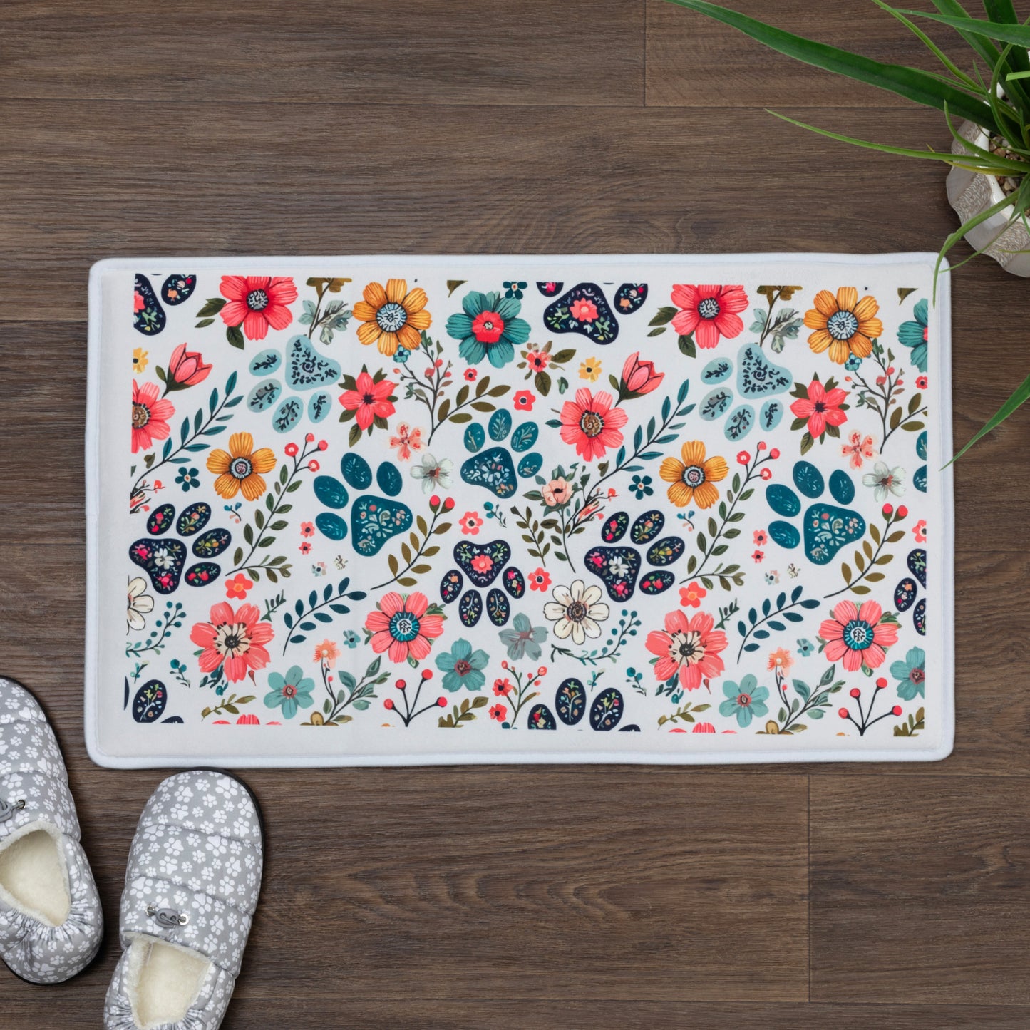 Floral patterned rug on a wooden floor with slippers and a plant.