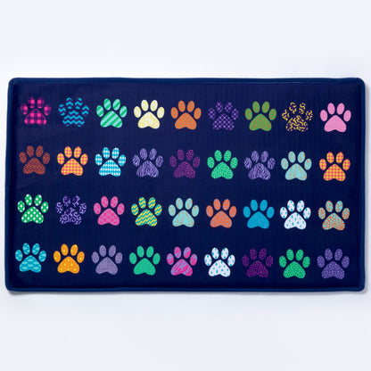 Navy blue mat with colorful paw prints on a white background