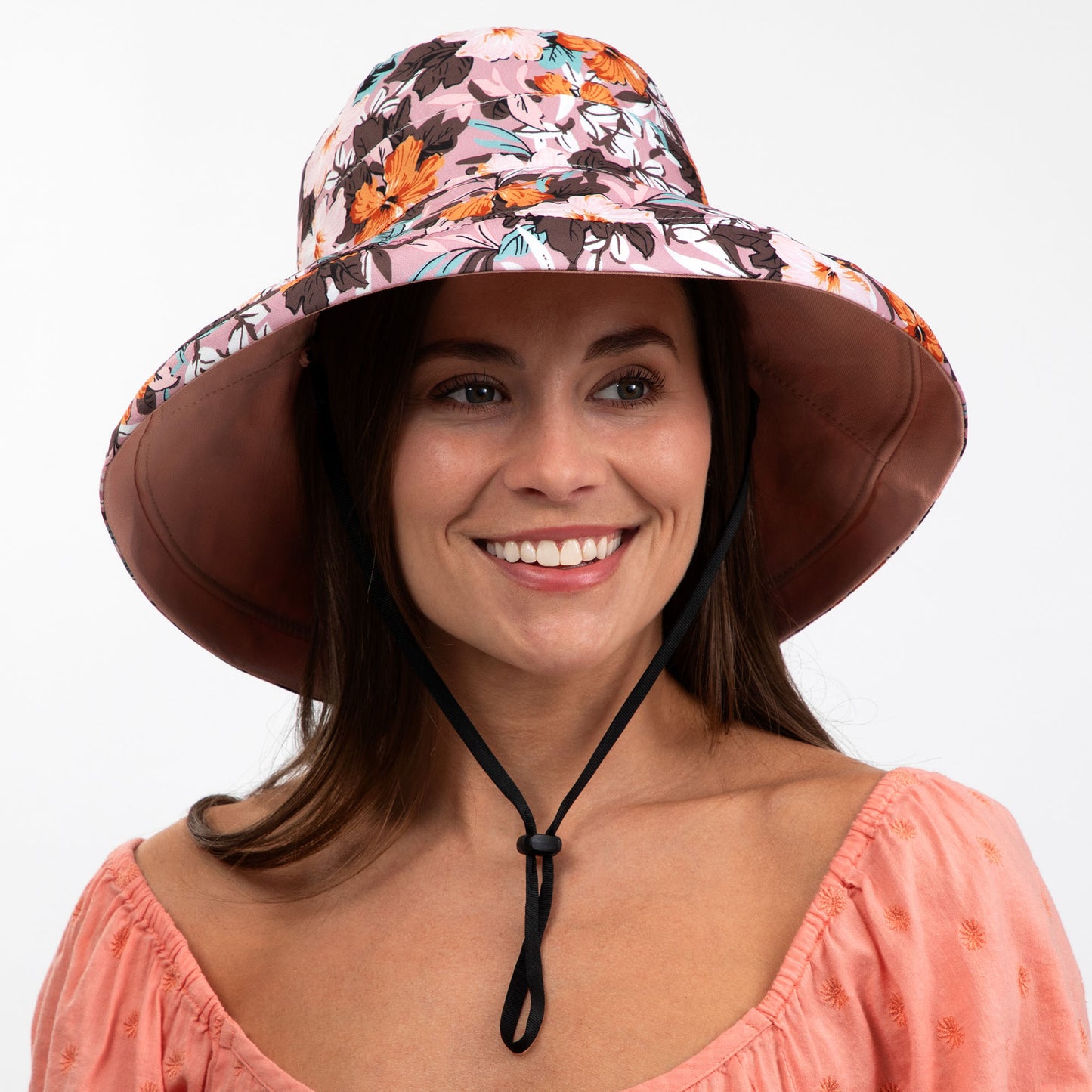 Woman wearing a floral sun hat on a white background
