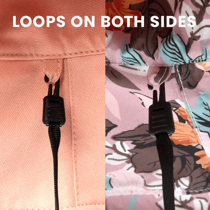 Close-up of a strap with loops on both sides on a floral-patterned fabric background.