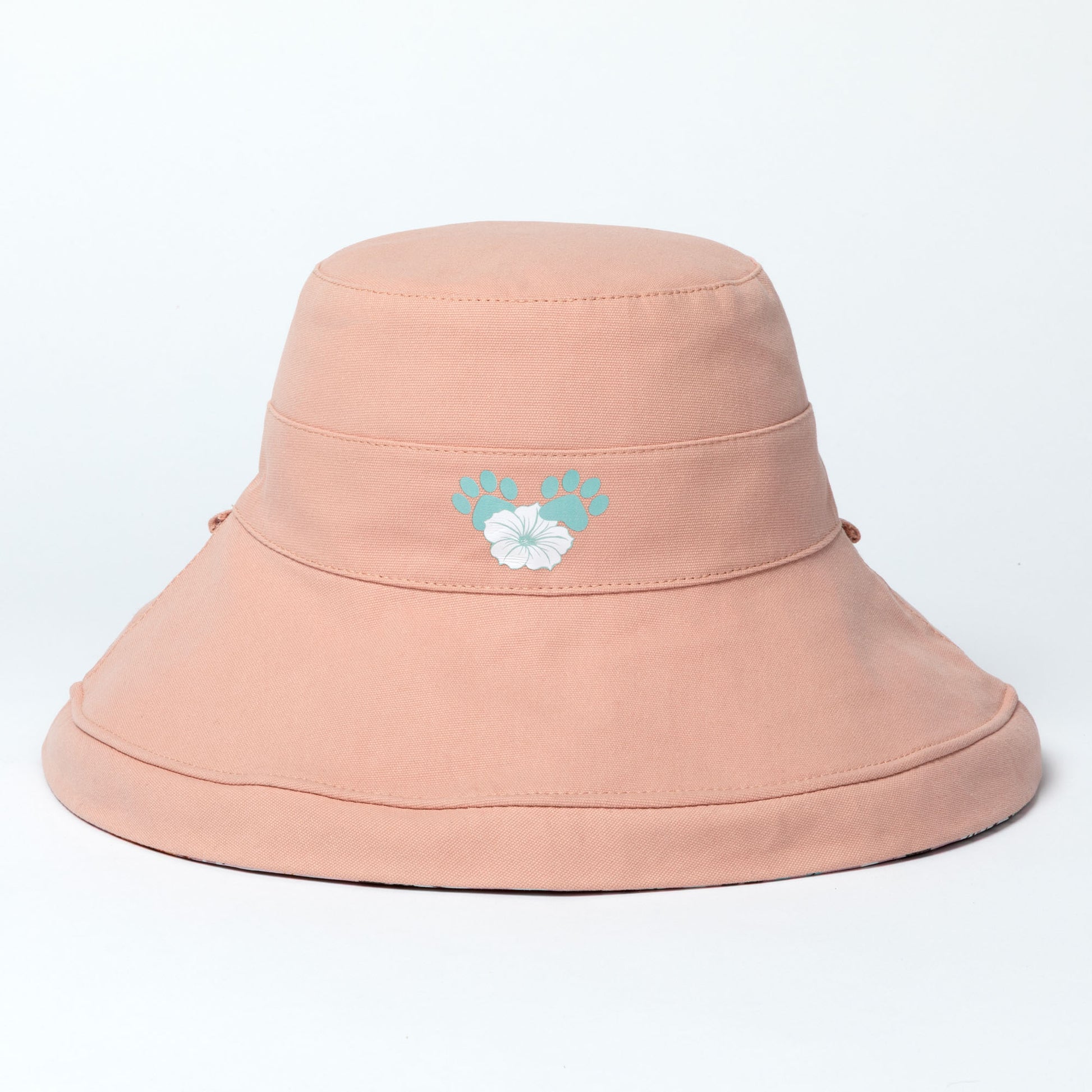 Pink wide brim sun hat with a floral design on a light gray background