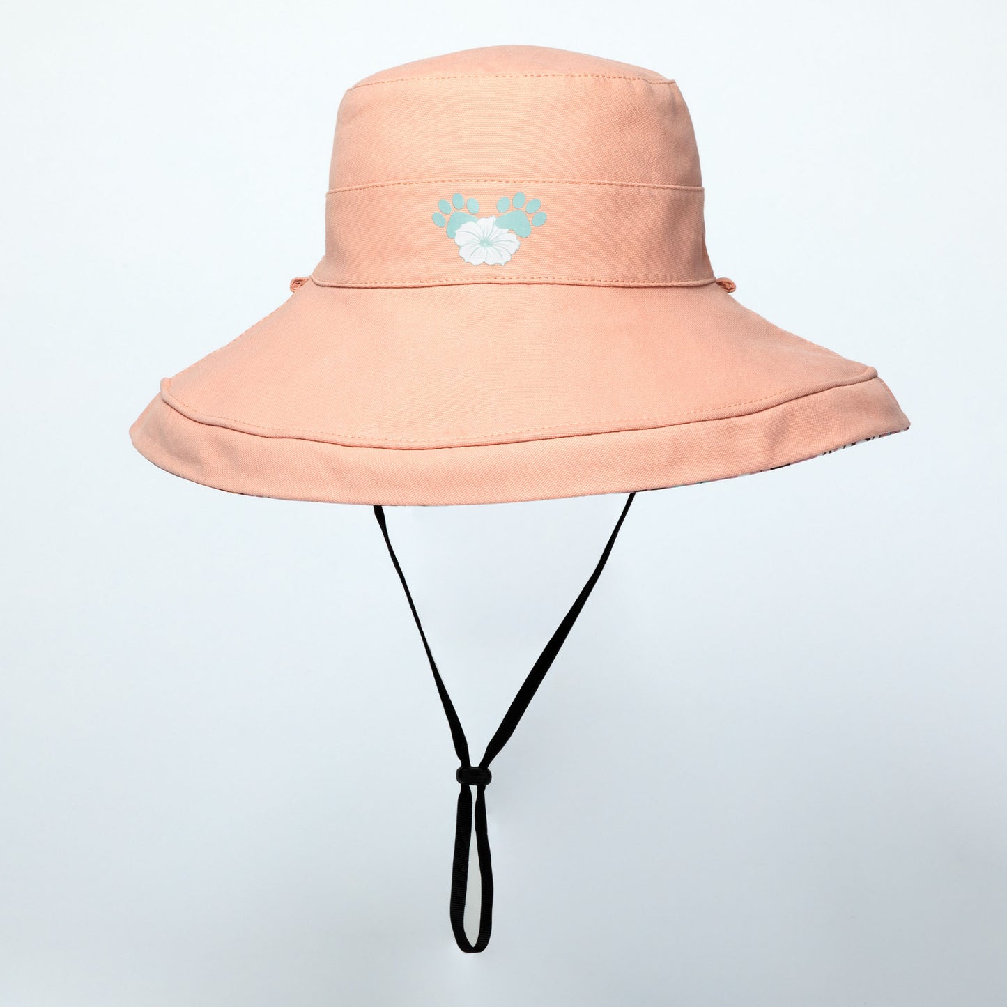 Pink wide brim sun hat with a black strap on a light gray background