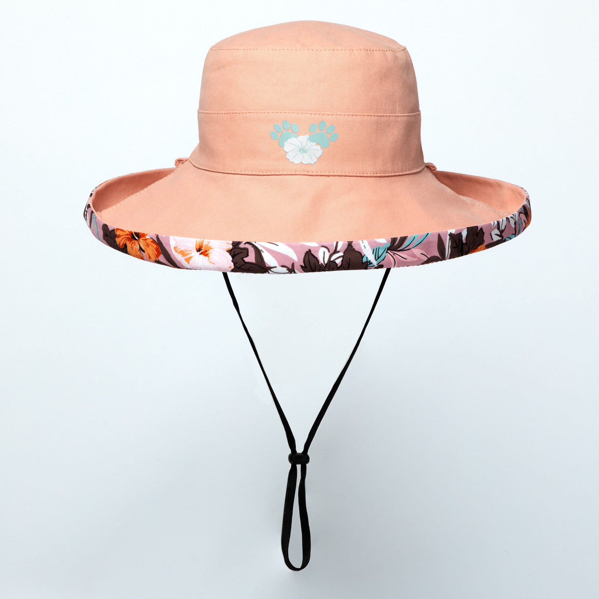 Pink wide brim sun hat with floral band and paw print logo on a light gray background
