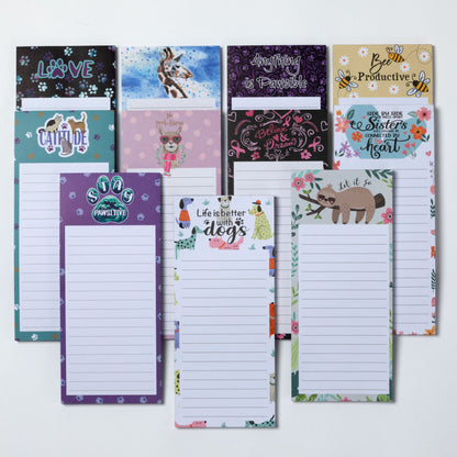 Collection of various themed notepads on a white background