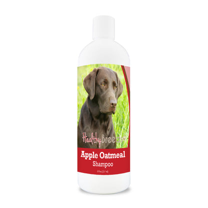 Bottle of apple oatmeal shampoo for dogs featuring a chocolate Labrador on the label.