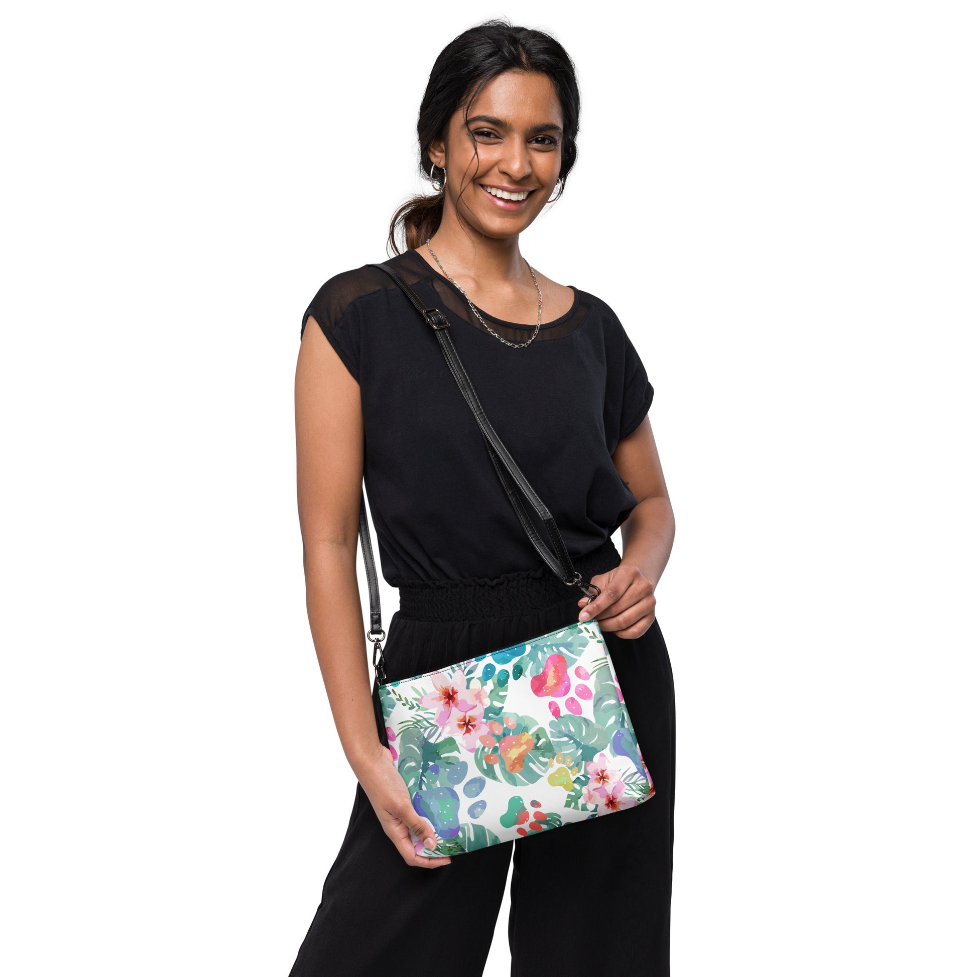 Woman holding a floral-patterned handbag against a white background