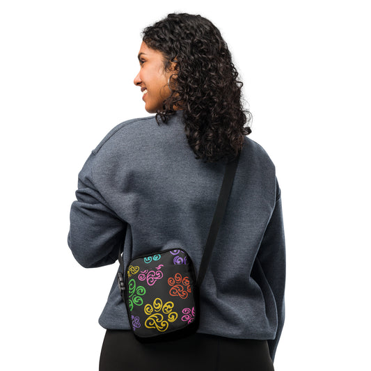 Person wearing a gray sweatshirt with a colorful patterned bag over their shoulder on a white background